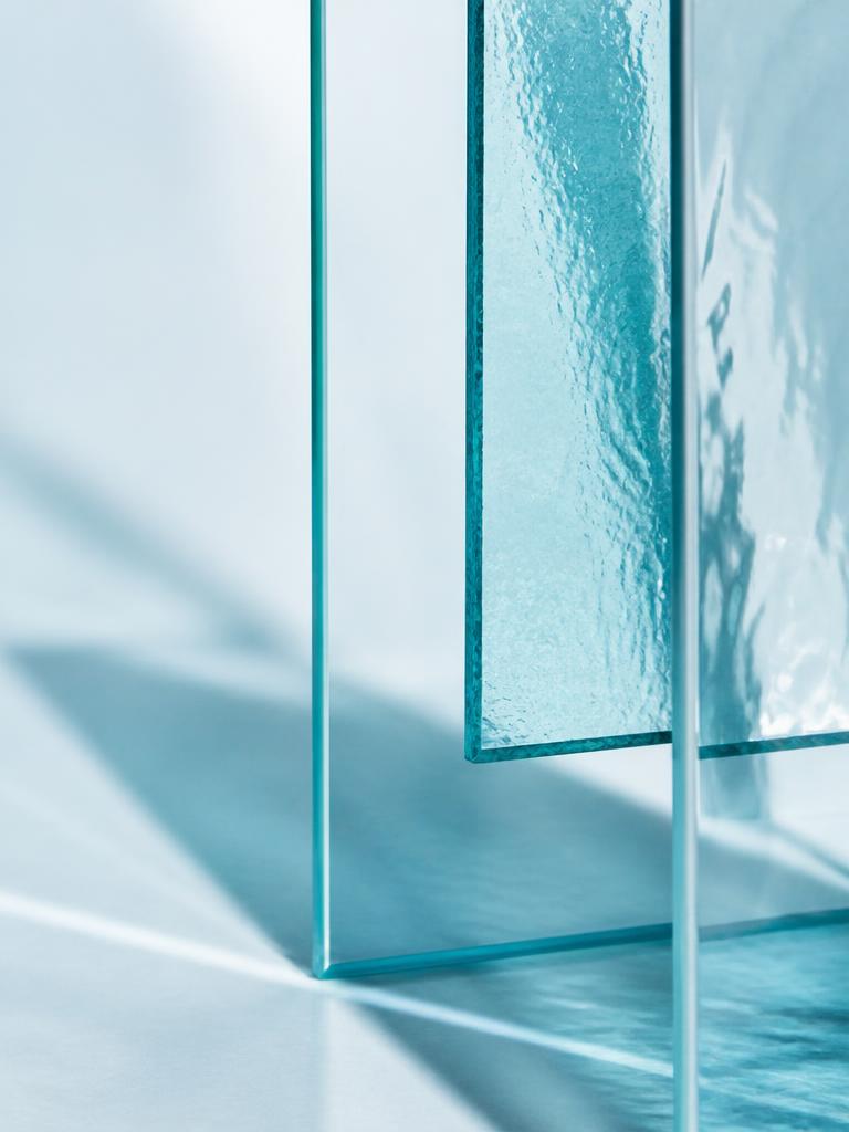 Layered translucent glass panels representing curated media supply